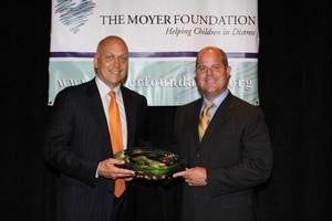  two men holding award Brotherton Cadillac in Renton WA